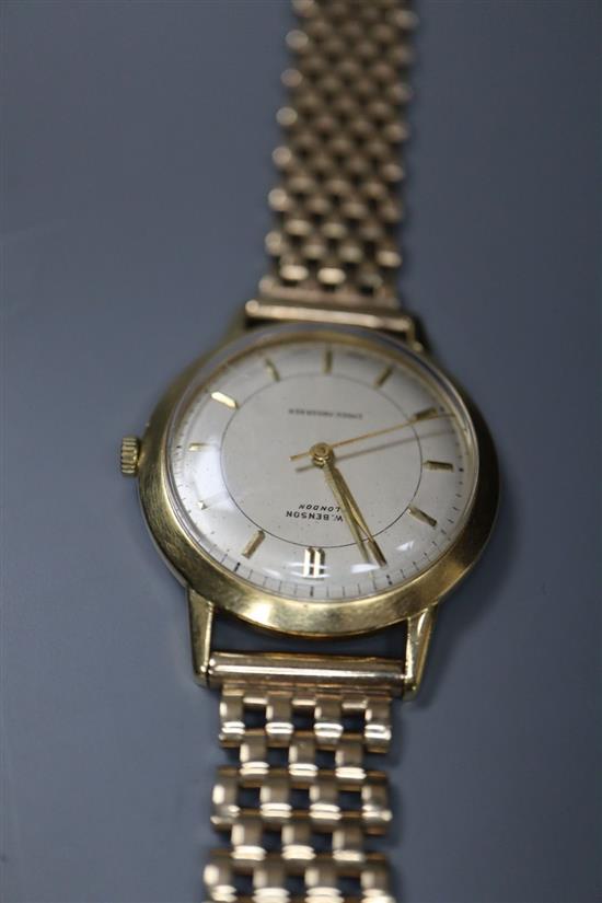 A gentlemans 18ct gold manual wind wrist watch, retailed by J.W. Benson, on a 9ct gold bracelet, gross 49.7 grams.